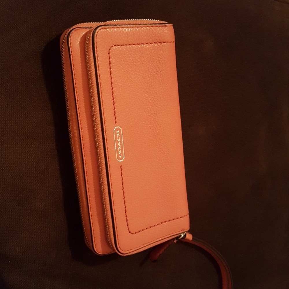 Coral colored leather Coach wallet